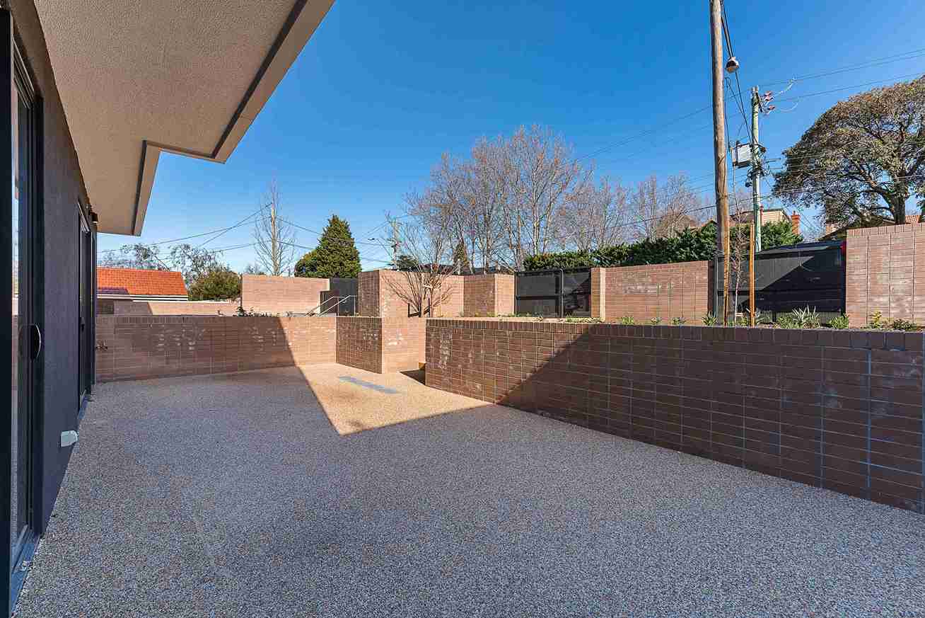 brick-courtyard-with-gravel-flooring-under-blue-sk-2026-03-26-07-12-02-utc_11zon concrete patios